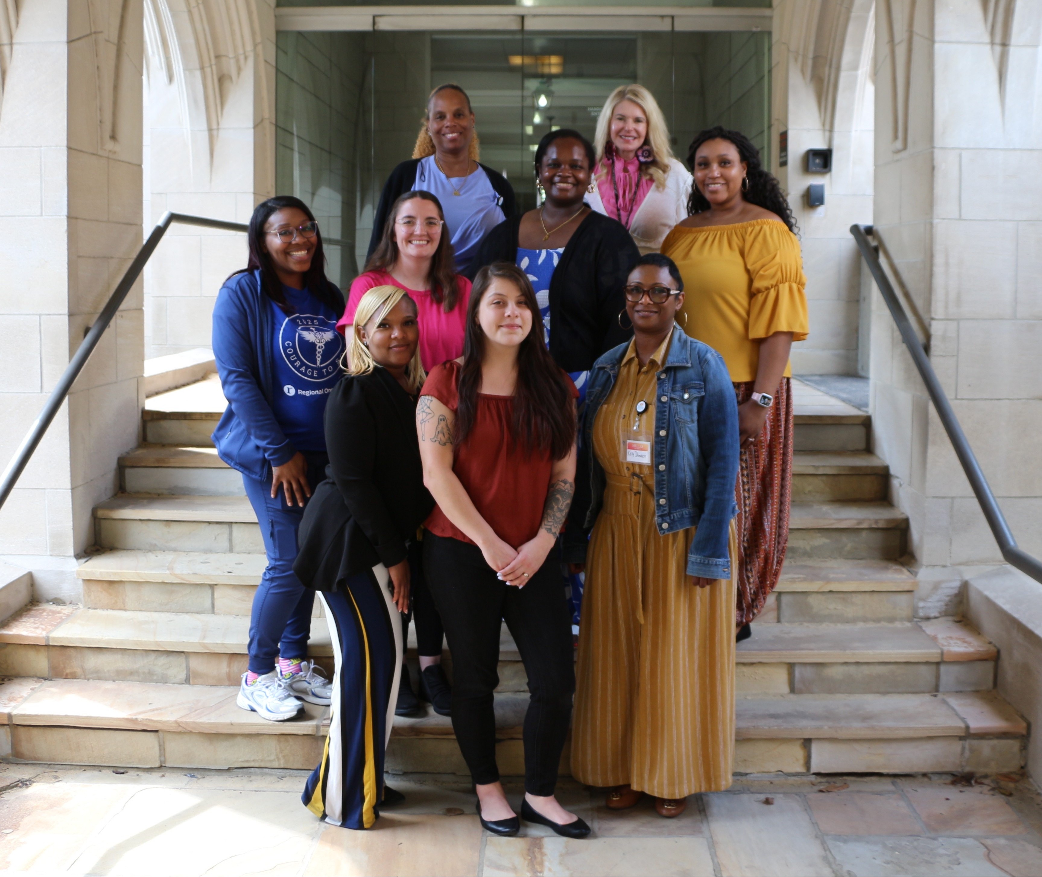 women standing on steps
