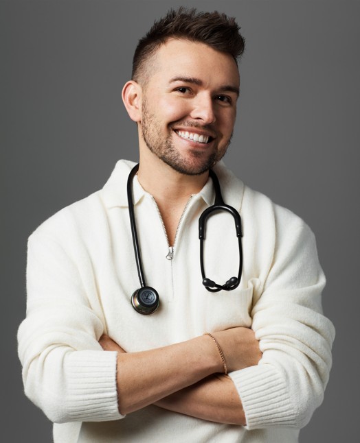 man in white sweater wearing stethoscope